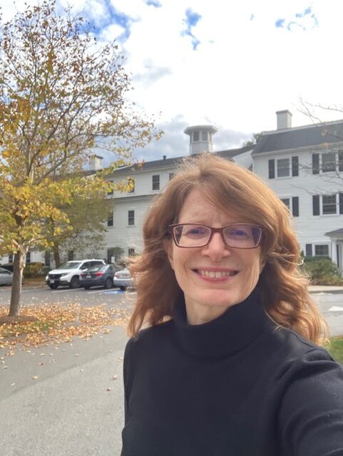 Caroline in black turtleneck in an autumn residential area